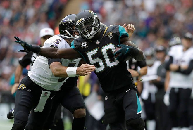 Jaguars outside linebacker Telvin Smith (50) returns a fumble recovery as Baltimore Ravens quarterback Joe Flacco (5) tries to tackle him during the teams’ game in London last month. (AP Photo/Matt Dunham)