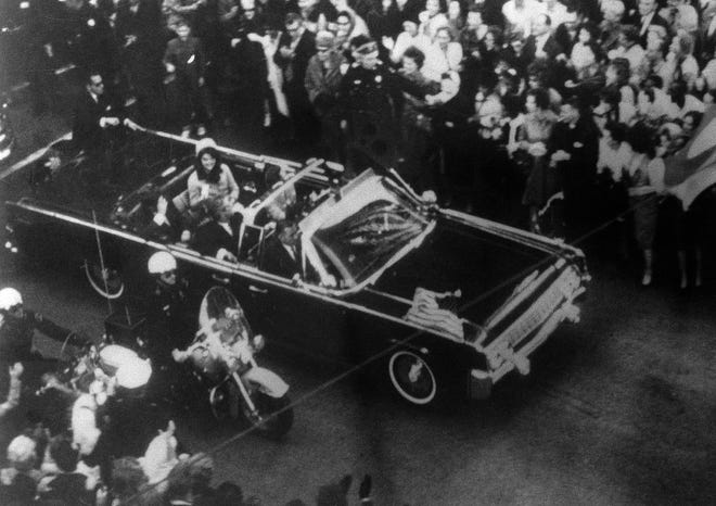 This image provided by the Warren Commission is an overhead view of President John F. Kennedy's car in Dallas motorcade on Nov. 22, 1963, and was the commission's Exhibit No. 698. Special agent Clinton J. Hill is shown riding atop the rear of the limousine. President Donald Trump is caught in a push-pull on new details of Kennedy’s assassination, jammed between students of the killing who want every scrap of information and intelligence agencies that are said to be counseling restraint. How that plays out should be known on Oct. 26, 2017, when long-secret files are expected to be released. (Warren Commission via AP)