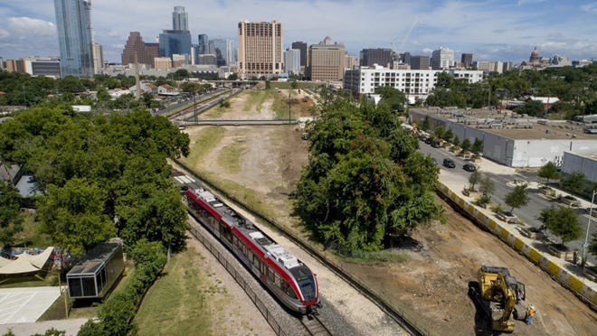 A MetroRail train runs along the Plaza Saltillo site in East Austin as construction begins on a mixed-use development on the Capital Metro-owned land. JAY JANNER / AMERICAN-STATESMAN