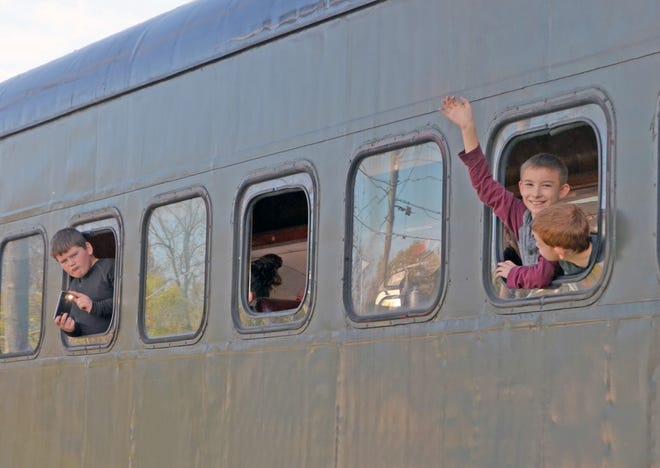 Kids wave from the Little River Railroad as they depart from Coldwater on the color tour last weekend. Don Reid Photo
