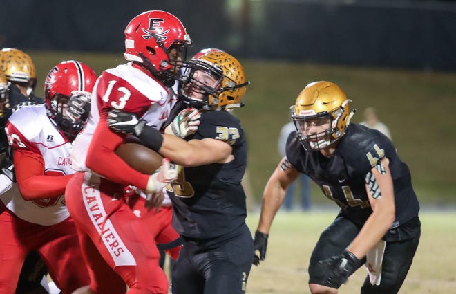 Shelby lineback Will Stites, 33, with Dax Hollifield, 44, on the way, stack up East Rutherford ballcarrier Demetrius Mauney, 13, Friday night at Pearley Allen Field. [David Grose / Special to The Star]
