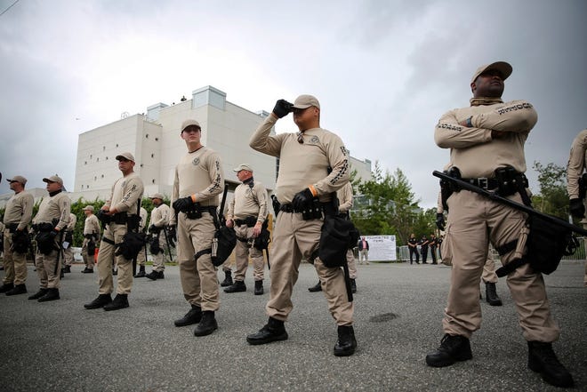 Law enforcement officers line in front of the Hard Museum of Art on the University of Florida campus on one of the streets closed for white supremacist Richard Spencer's speech on Oct. 19. [Will Vragovic/Tampa Bay Times via AP]