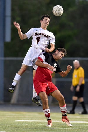 Jackson Filosa, of Ipswich, heads the ball, beating out Pat Ivers of Amesbury on Sept. 20. The Tigers played Amesbury on Oct. 24 needing a win to stay alive for tournament contention. [Wicked Local Staff Photo / David Sokol]