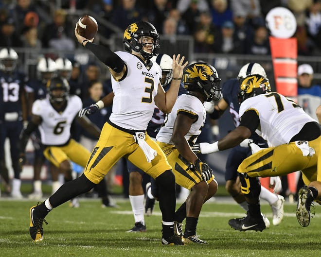 Quarterback Drew Lock (3) threw for 377 yards and five touchdowns as Missouri routed UConn 52-12 on Saturday night, winning back-to-back games for the first time since the start of the 2015 season. Lock is the first Tigers quarterback to throw for at least five touchdowns five times. He has 7,298 yards passing and trails only Brad Smith (8,799 yards) and Chase Daniel (12,515 yards) on Missouri's all-time passing list. [Jessica Hill/The Associated Press]