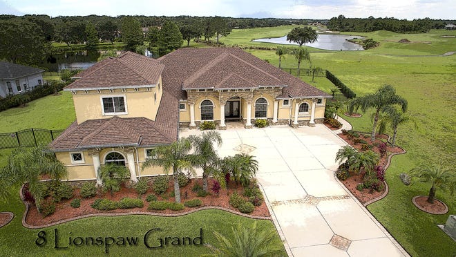 The property at 8 Lionspaw Grand in the LPGA International community offers plenty of privacy and golf course views. [Photos provided]