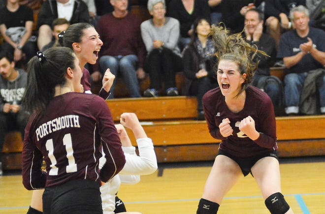 Portsmouth players, from left, Georgia Dickinson, Eli Omahen and Annah Shaheen celebrate a point during Saturday night's Division II quarterfinal match at St. Thomas. Portsmouth won in four sets. [Mike Whaley/Fosters.com]