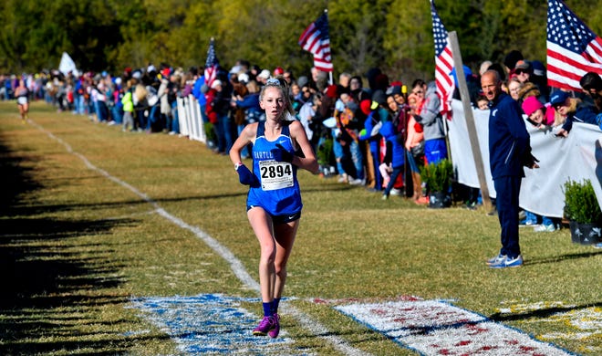 Bartlesville runner Rilee Rigdon crosses the finish line to win the individual state championship during the 5a/6a OSSAA Cross Country State Championship held at Edmond Sante Fe in Edmond, Okla., on Saturday, October 28, 2017. Photo by KT King, For the Oklahoman
