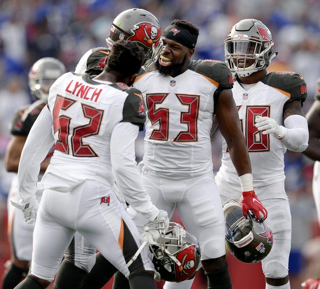 Tampa Bay Buccaneers linebackers Adarius Glanton (53) and Cameron Lynch (52) celebrate a defensive fumble recovery during the second half against the Buffalo Bills Oct. 22 in Orchard Park, N.Y. [The Associated Press / Adrian Kraus]