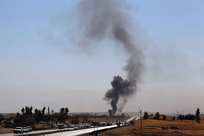 Smoke rises as Iraqi security forces launch explosives as Kurdish security forces withdraw from a checkpoint in Altun Kupri, on the outskirts of Irbil, Iraq, Friday Oct. 20, 2017.