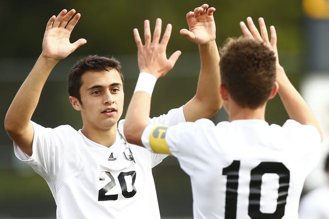 Frankie Fernandez #20 of Quaker Valley is congratulated by his teammate Landon Grant #10 following his goal in the first half agains McGuffey during the first round of the WPIAL playoffs. Quaker Valley will meet Shady Side Academy in the Class 2A championship game. (Photo by Jared Wickerham/For The Beaver County Times)