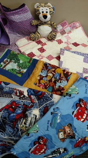 Pictured are a portion of blankets Michelle Roudebush hand-quilted.