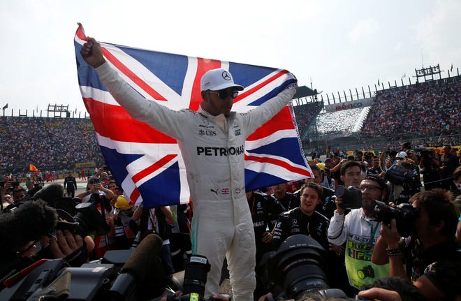 Mercedes' Lewis Hamilton celebrates Sunday after winning his fourth F1 championship at the Mexican Grand Prix in Mexico City, Mexico. [REUTERS/Henry Romero]