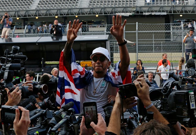 Mercedes driver Lewis Hamilton, of Britain, celebrates at the pit lane after the Formula One Mexico Grand Prix auto race at the Hermanos Rodriguez racetrack in Mexico City, Sunday, Oct. 29, 2017. Hamilton won his fourth career Formula One season championship on Sunday with a ninth-place finish at the Mexican Grand Prix in a race won by Red Bull's Max Verstappen. (AP Photo/Marco Ugarte)
