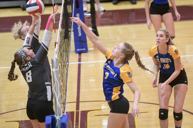 St. Vincent’s Academy’s Jessica Schwarz (9) hits against the block of Coosa as Emma Wyman (14) backs her up during the GHSA Class 2A state volleyball championship on Saturday in Atlanta. Coosa defeated defending champion SVA 25-23, 25-20, 27-25. (John Amis/For the Savannah Morning News)