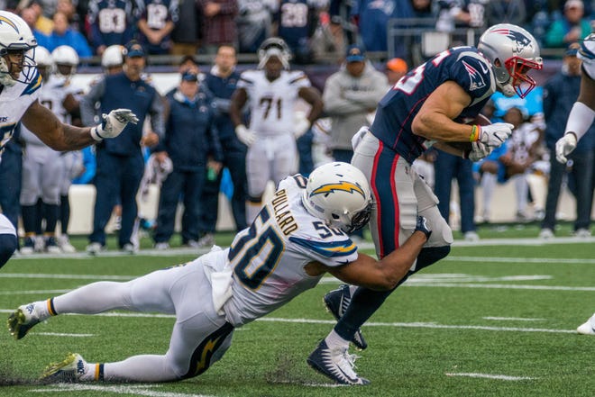 Patriots wide receiver Chris Hogan gets dragged down by the Chargers' Hayes Pullard before getting hit by another defender, forcing him to leave the game with an injury. [JOSH SOUZA/STANDARD-TIMES SPECIAL/SCMG]
