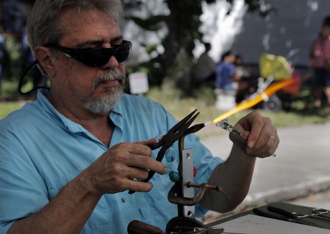 Jay McIver hand sculpts glass at the 43rd Micanopy Fall Festival Oct. 28, 2017 in Micanopy, Fla. The festival runs along Cholakka Boulevard and features local artists, crafters and musicians from Saturday Oct. 28, through Sunday Oct. 29 until 4 p.m.[Kaila Jones/Correspondent]