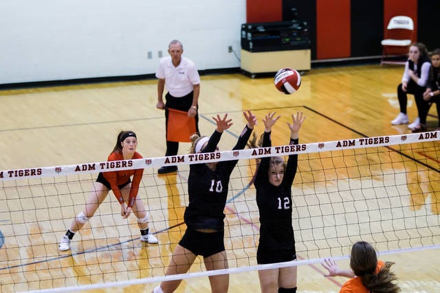 Gilbert's Inga Rotto and Taylor Grinley put up up a double block against a Red Oak attacker during the Tigers' four-set loss in a Class 3A regional final on Monday night in Adel. Photo by Debbie Gray/Special to the Tribune