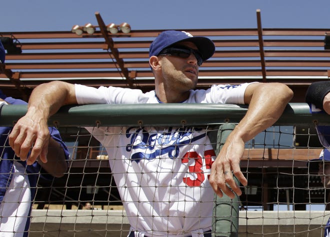 FILE - In this March 24, 2011, file photo, Los Angeles Dodgers' Gabe Kapler stands in the dugout before the Dodgers' spring training baseball game against the Colorado Rockies in Glendale, Ariz. Kapler will be hired to manage the Philadelphia Phillies, according to a person familiar with the decision. The person spoke to The Associated Press on condition of anonymity because an official announcement hasn't been made. [AP Photo/Nam Y. Huh, File]