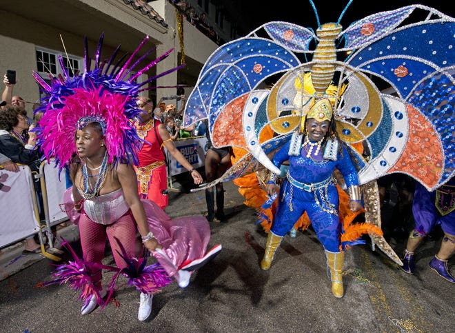 In this Saturday, Oct. 28, 2017 photo provided by the Florida Keys News Bureau, Caribbean dancers prance down Duval Street to end the Fantasy Fest Parade in Key West, Fla.¬† The parade was the highlight event of the 10-day Fantasy Fest masking and costuming festival, themed "Time Travel Unravels," that ends Sunday, Oct. 29. The parade attracted tens of thousands of partiers and occurred about seven weeks after Hurricane Irma passed through the Florida Keys on Sept. 10. (Andy Newman/Florida Keys News Bureau via AP)