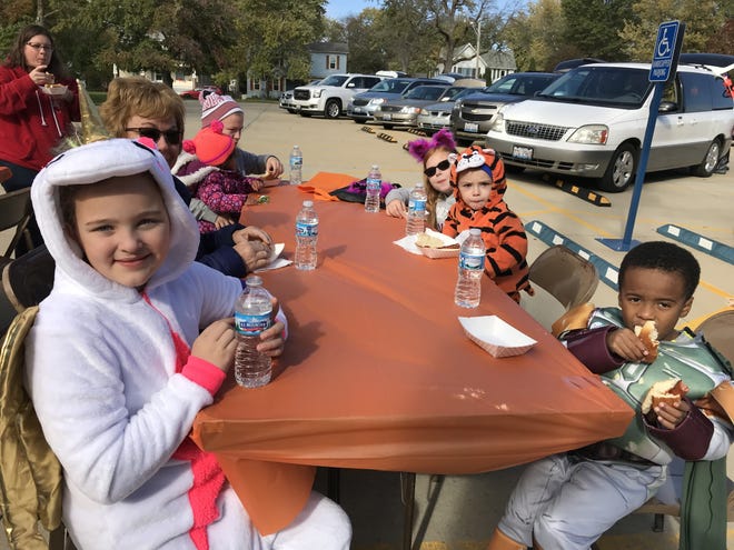 Keziah Cheger,right, Moni, Tate Frontone and Kyleigh Ott enjoy a hotdog at the St. John’s United Church of Christ in Lincoln’s Trunk or Treat event Sunday in Lincoln. When asked why they choose to spend their afternoon at the church they all agreed, “It was the candy!” [Photo by Jean Ann Miller/The Courier]