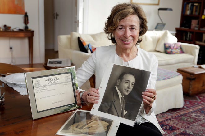 Lauren Friedman, daughter of lawyer Samuel Friedman, poses with photos of her father, and a telegram from Thurgood Marshall, in her New York apartment, Monday, Oct. 23, 2017. A new movie about Thurgood Marshall focuses on a rape case he worked on, well before he won a landmark school desegregation case and a quarter-century before he became a Supreme Court justice. In early 1941, Marshall was in Bridgeport, Conn., to represent Joseph Spell, a black chauffeur accused by his wealthy, white employer of rape. Because Marshall was an out-of-state attorney, he enlisted the help of a local lawyer, Sam Friedman, who was white and had expertise in trying civil cases, not criminal ones. (AP Photo/Richard Drew)
