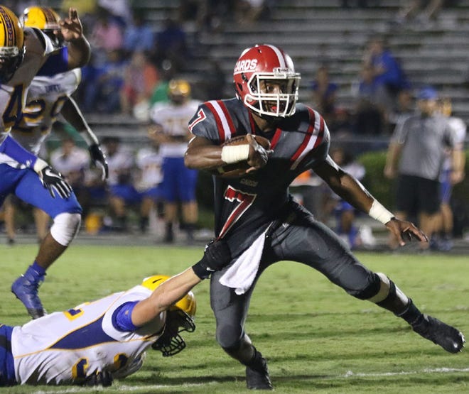 Jacksonville's Justyn Benton tries to break a tackle during a game against Laney earlier this season. The Cardinals visit Havelock on Friday night with the winner clinching the Coastal 3-A Conference title. [John Althouse/The Daily News]
