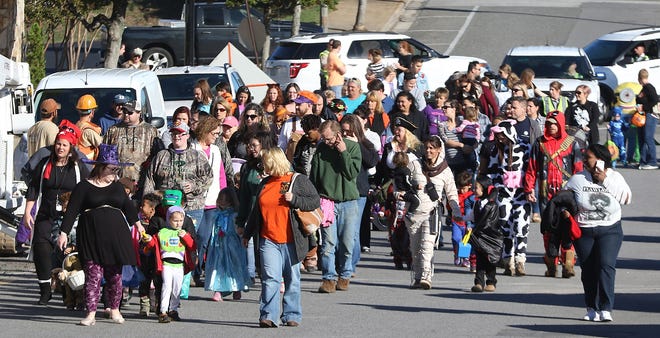 Hundreds of people walk along Railroad Avenue on their way to Patriots Park in downtown Kings Mountain Tuesday morning, Oct. 31, 2017, as part of the Kings Mountain Great Pumpkin Halloween Parade event. [Mike Hensdill/The Gaston Gazette]