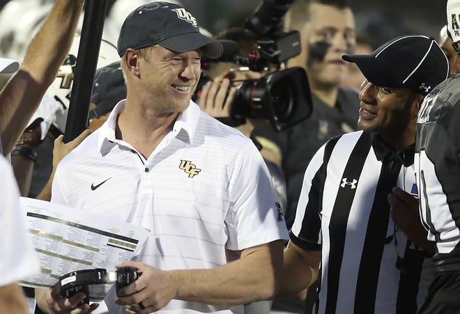 UCF coach Scott Frost smiles as he chats with a game official Saturday during the game against Austin Peay at Spectrum Stadium in Orlando. Frost is an ideal candidate to become Florida's next football coach. [Stephen M. Dowell/Orlando Sentinel]