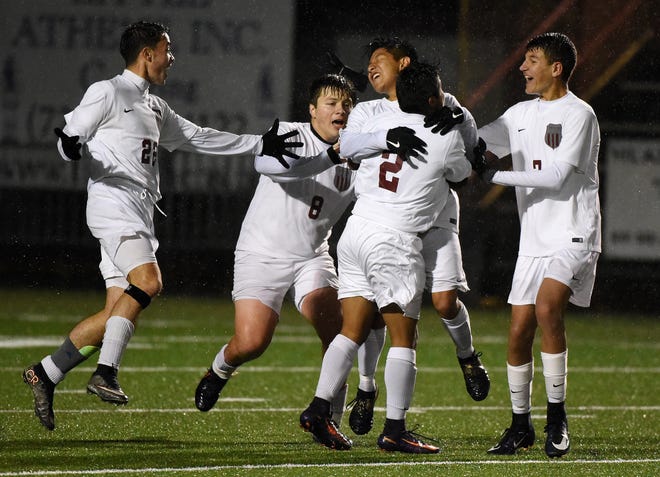Beaver's Eli Obrist (2) hugs Gabe Obrist (6) while celebrating Gabe's double-overtime goal with teammates, from left, Aidan Perez (22), Danyal Dikec (8), and Zachary Bowser (7) during Beaver's 3-2 win over Central Valley on Wednesday at Ambridge Area High School. [Kevin Lorenzi/BCT STAFF]