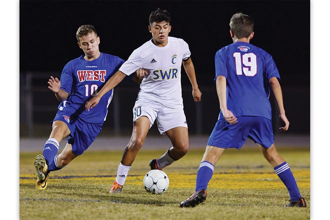Southwestern Randolph's Fernando Abonza, center, looks to get past West Henderson's Maks Koch, left, and Matthew Pitcavage on Wednesday in the opening round of the NCHSAA 3-A playoffs.