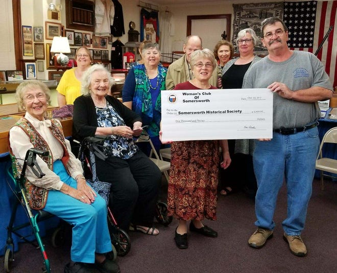 Members of the Somersworth Woman's Club present a check to the Summersworth Museum and Historical Society. Back row, from left, Sue Eastman, Robin Janetos, Louis Janetos, Cynthia Jutras, Julie Hurley. Front row, from left, Ester Eastman, Elenore Janetos, Susan McCoy and George Poulin. [Photo courtesy of Jenne Holmes]