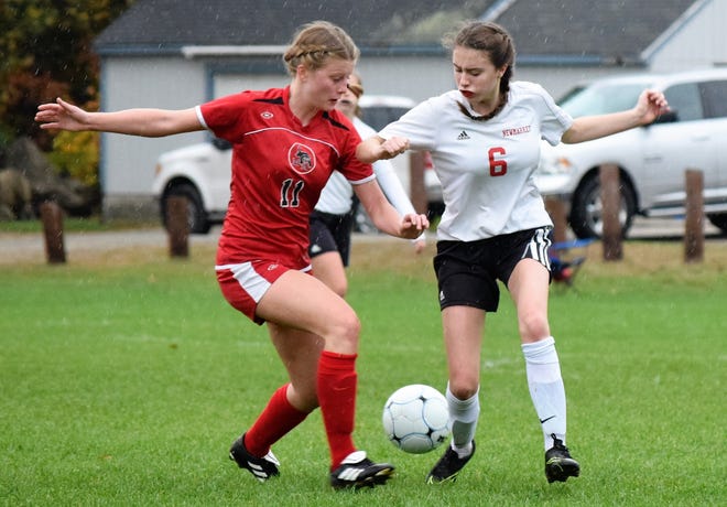 Newmarket High School back Nicole Berry, right, fights for the ball with Moultonborough’s Zoe Norton during their Division IV quarterfinal game on Sunday in Newmarket. [Mike Zhe/Seacoastonline]
