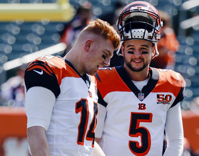Cincinnati Bengals quarterbacks AJ McCarron (5) and Andy Dalton (14) talk before a NFL game against the Baltimore Ravens in Cincinnati. A deal was reached to send McCarron to the Browns, but all the paperwork wasn't submitted to the league office before the trade deadline. [AP Photo/Frank Victores]