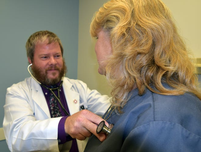 Dr. Daniel Paul, with CarolinaEast Internal Medicine, begins a physical exam at his office in New Bern. [CHARLIE HALL/ SUN JOURNAL]