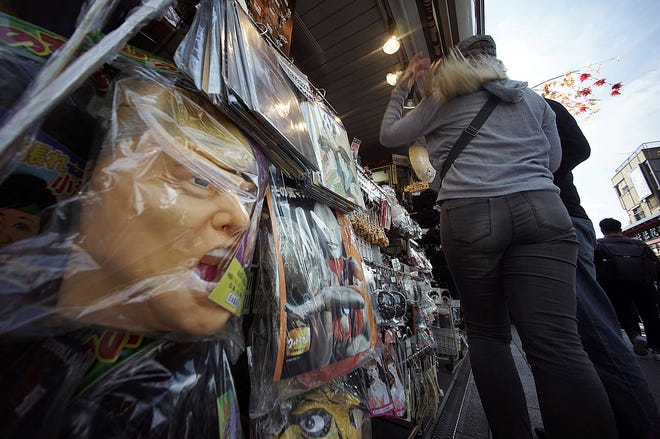 Some rubber masks including of U.S. President Donald Trump are sold in Tokyo Thursday, Nov. 2, 2017. During his first months as president, Trump, who will visit Japan, South Korea and China before attending regional summits in Vietnam and the Philippines, has blended moments of flattery with vows to rip up trade deals, destroy a sovereign nation with nuclear weapons and generally crash long-standing norms of diplomacy anywhere it suits his aims. (AP Photo/Eugene Hoshiko)