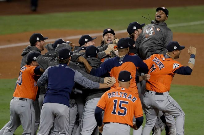 The Houston Astros celebrate their 5-1 win over the Los Angeles Dodgers in Game 7 of the World Series on Wednesday in Los Angeles. The Astros won the series 4-3. [Alex Gallardo/The Associated Press]
