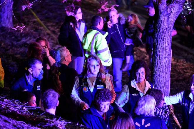 Walmart employees gather together outside away from the scene of the Walmart store where a shooting occurred inside the store, Wednesday, Nov. 1, 2017, in Thornton, Colo. Thornton police tweeted Wednesday night that they were responding to a shooting with "multiple parties down." They advised people to stay away from the area as dozens of police cruisers and emergency vehicles raced to the scene. (Helen H. Richardson/The Denver Post via AP)