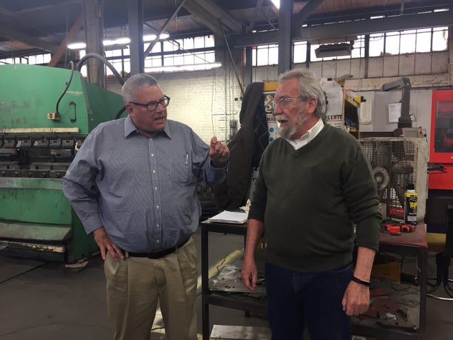 Iowa Secretary of Agriculture Bill Northey, left, talks with Flint Cliffs Manufacturing Vice President of Sales Steve Standard Wednesday during a tour of the metal fabrication facility in Burlington. [Elizabeth Meyer/thehawkeye.com]