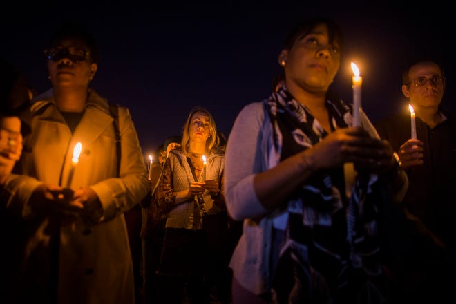 People gather to remember the victims of the recent truck attack during a candle light walk along the Hudson River near the crime scene on Thursday, Nov. 2, 2017, in New York. A man in a rental truck mowed down pedestrians and cyclists along the busy bike path near the World Trade Center memorial on Tuesday, killing at least eight people and seriously injuring others in what the mayor called "a particularly cowardly act of terror." (AP Photo/Andres Kudacki)