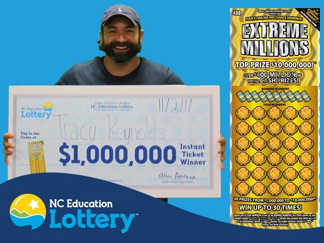Tracy Reynolds of Lincolnton is all smiles while holding his $1 million lottery prize. [Special to The Star]