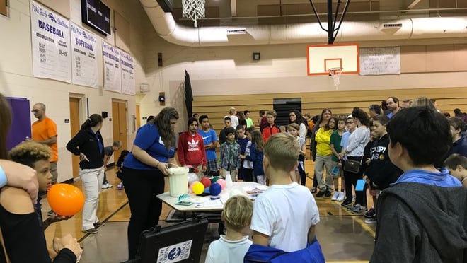 Students gather around a liquid nitrogen demonstration at Polo Park Middle School's fifth annual Night of Science on Oct. 25 in Wellington. (Provided)