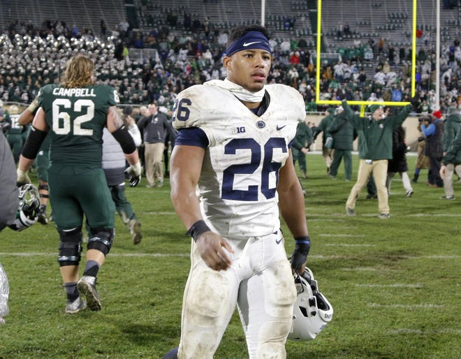 Penn State's Saquon Barkley (26) walks off the field after Michigan State won 27-24 on a last-second field goal. [AP Photo/Al Goldis]