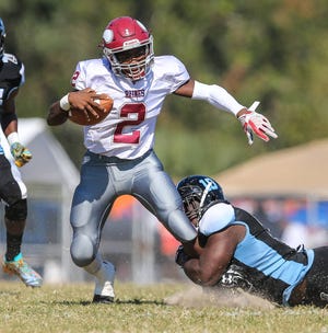 Raines’ Raynell Killian scores on a 35-yard catch-and-run vs. Ribault on Saturday. (For The Florida Times-Union/Gary Lloyd McCullough) Raines quarterback Ivory Durham is hit by Ribault’s Dagoberto Norales during the Northwest Classic on Saturday at Ribault High School. (For The Florida Times-Union/Gary Lloyd McCullough)