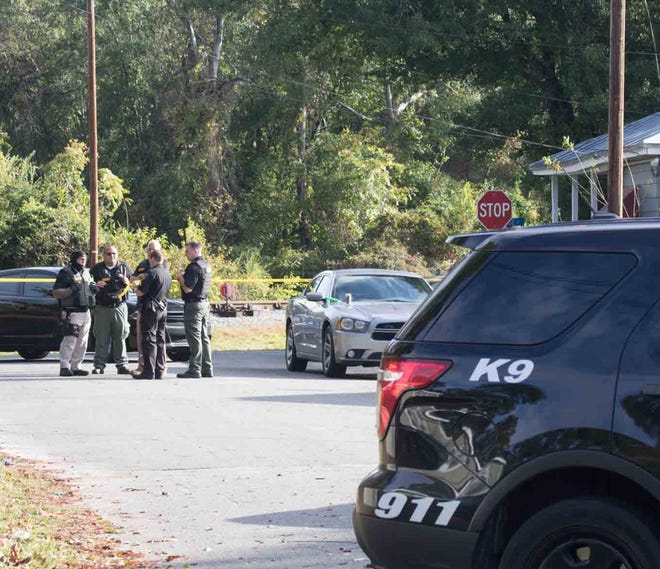 Officers discuss a drug search at 1105 LaGrange St., in New Bern on Oct. 24 The home was one of several searched in an ATF-led anti-drug raid that local authorities said targeted a major drug ring in Craven County. [BILL HAND / SUN JOURNAL STAFF]