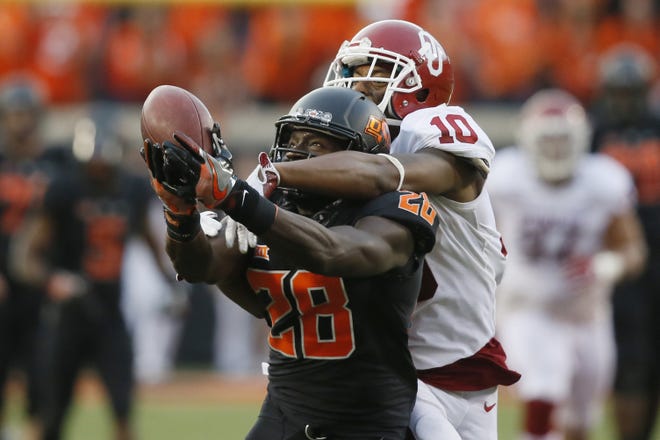 Oklahoma defensive back Steven Parker (10) defends as Oklahoma State wide receiver James Washington (28) reaches for a pass in the second half in Stillwater, Okla., on Saturday, Nov. 4, 2017. Oklahoma won 62-52. [AP Photo/Sue Ogrocki]