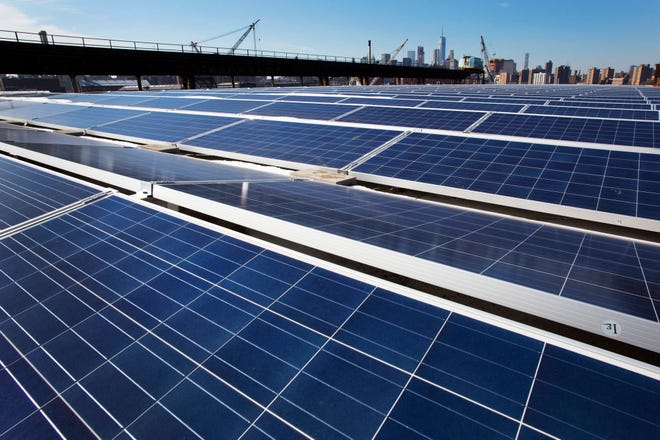 In this Feb. 14, 2017, file photo, a rooftop is covered with solar panels at the Brooklyn Navy Yard, Tuesday, Feb. 14, 2017, in New York. A U.S. trade commission is recommending that the Trump administration impose tariffs of up to 35 percent to slow an influx of low-cost solar panels imported from China and other countries. (AP Photo/Mark Lennihan, File)