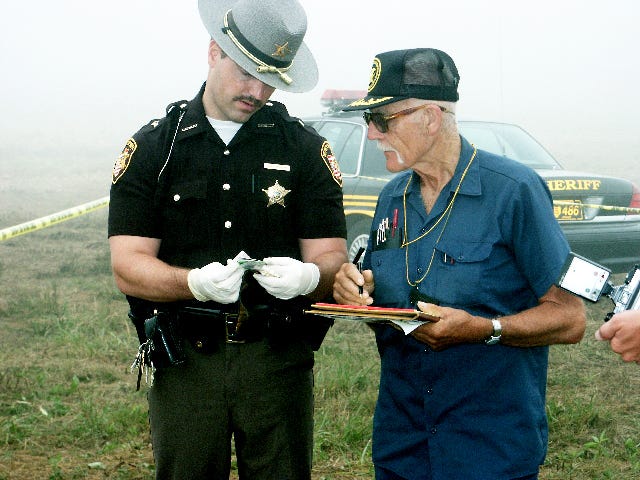 Pictured with retired Wayne County Sheriff’s Deputy Kurt Garrison, former Wayne County Coroner Dr. J.T. Questel played a role in countless death investigations. Questel, who served as coroner from 1969 to 2003, died Friday.