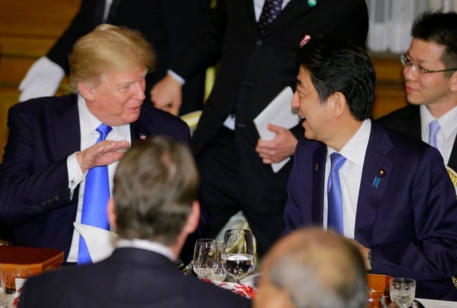 U.S. President Donald Trump talks with Japanese Prime Minister Shinzo Abe, right, during a state banquet hosted by Abe at Akasaka Palace in Tokyo, Monday, Nov. 6, 2017.
