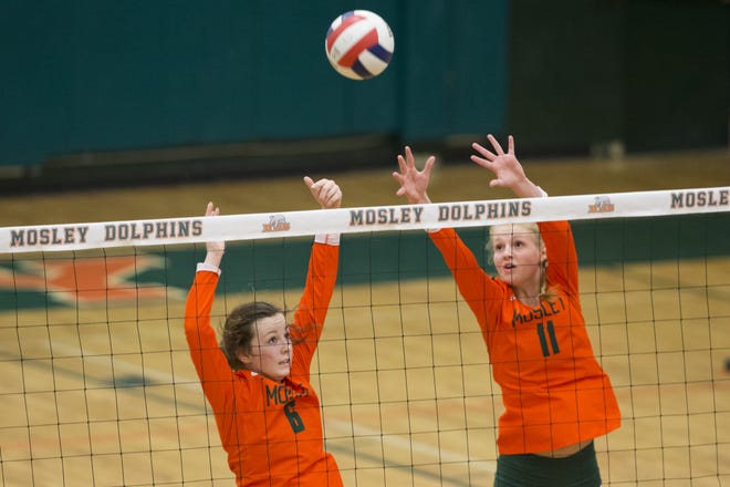 Mosley's Olivia Whittle (11) and Emma Robertson (8) go up to try to put a ball away during a region playoff match against Arnold. [JOSHUA BOUCHER/THE NEWS HERALD]