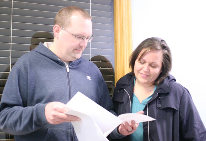 Millersburg councilman Brent Hofstetter and his wife Jenny look over the election results Tuesday evening at the Holmes County Board of Elections. All four incumbents on the Millersburg council were retained.